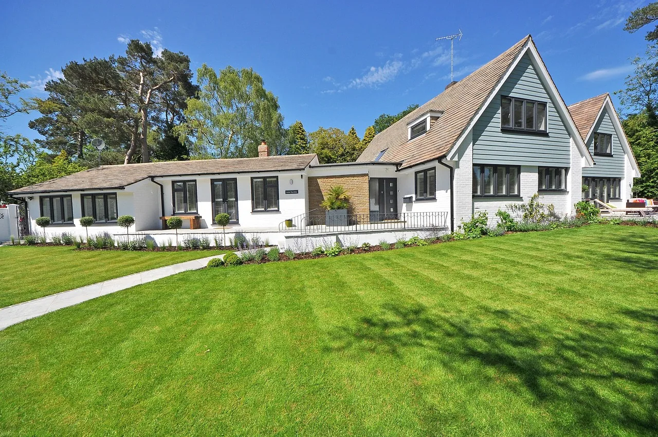Sunny lawn and garden in front of a house